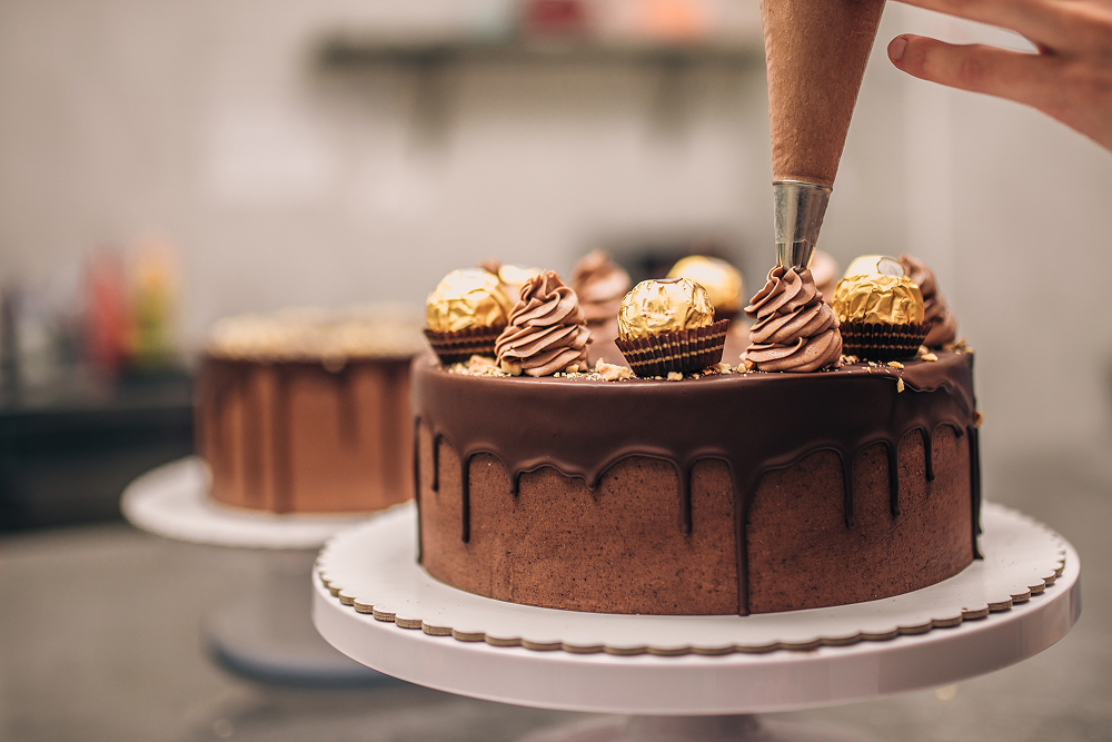 chocolate cake being decorated